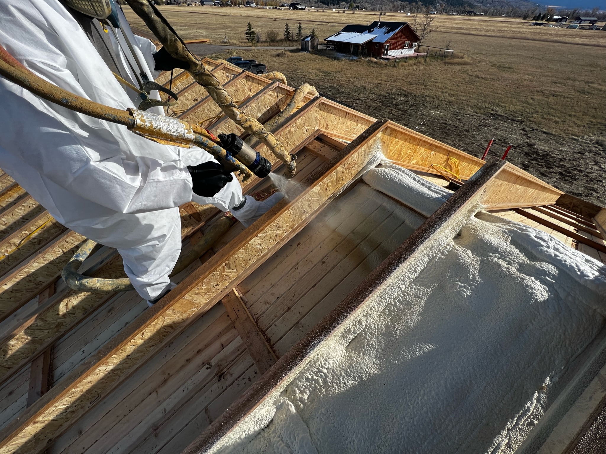 Closed cell spray foam insulation for roofs and ceilings by Cabinet Peaks Foam acts as a vapor barrier, prevents moisture, and reduces risk of mold and water damage, especially in areas with fluctuating or extreme weather, like harsh winters or humid summers.